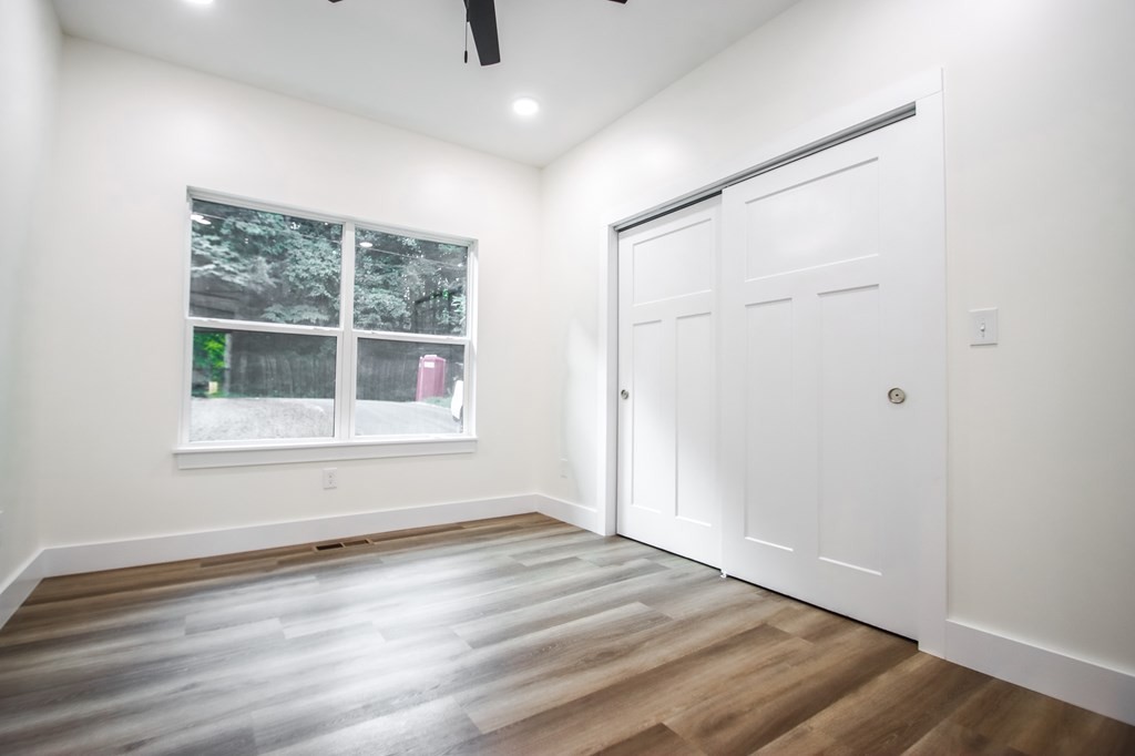 329 Webb Drive Sparta, TN 38583 - Photo 12 of 17 an empty room with wooden floor and windows