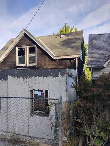 a front view of a house with sitting area