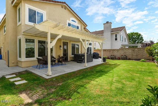 a view of a house with a backyard porch and sitting area