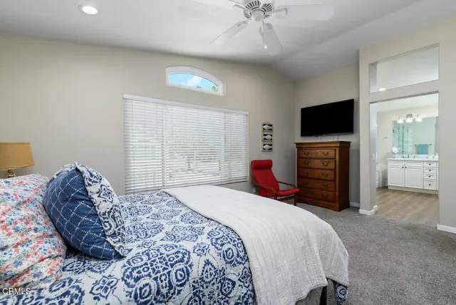 a bedroom with a bed and a television