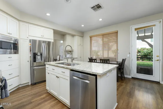 a kitchen with a sink stove and refrigerator