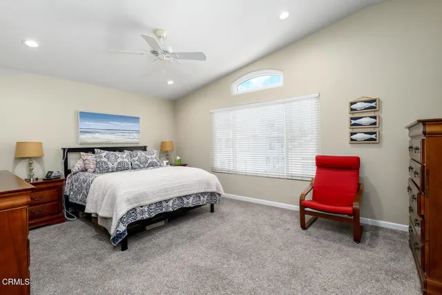 a spacious bedroom with a bed and window