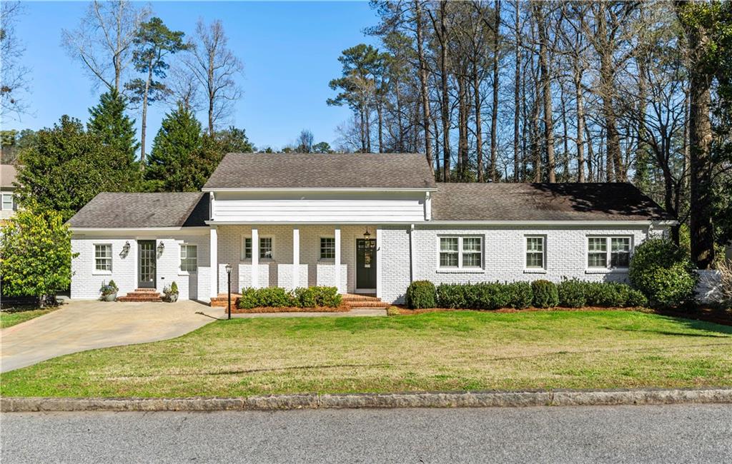 344 Pine Forest Road Northeast Atlanta, GA 30342 - Photo 1 of 1 a front view of a house with a yard