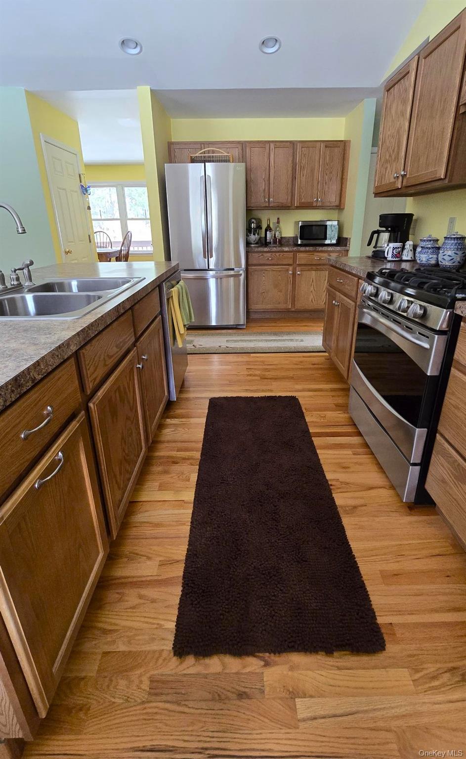 26 Valley Road Forestburgh, NY 12777 - Photo 16 of 32 a large kitchen with wooden floors and a stove