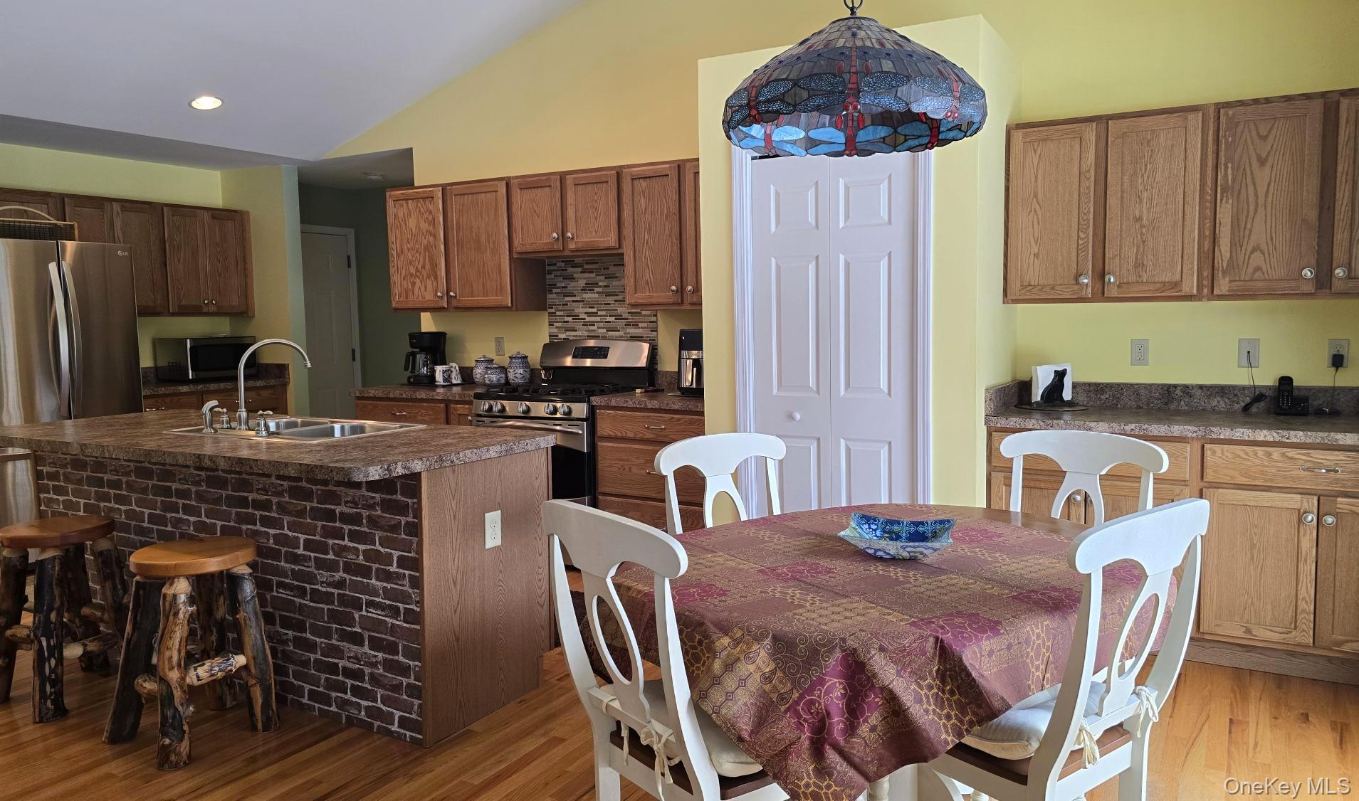 26 Valley Road Forestburgh, NY 12777 - Photo 17 of 32 a kitchen with a table chairs sink and cabinets