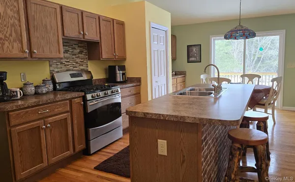 a kitchen with granite countertop a stove and white cabinets