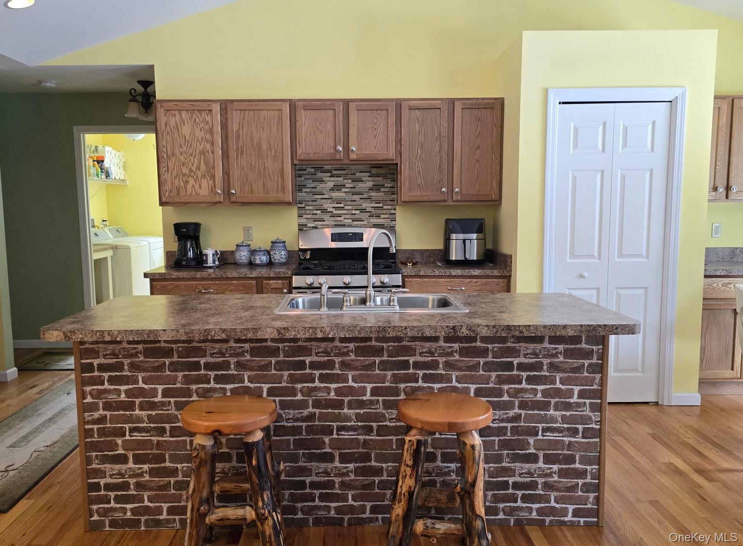 26 Valley Road Forestburgh, NY 12777 - Photo 19 of 32 a kitchen with kitchen island granite countertop a stove sink and cabinets