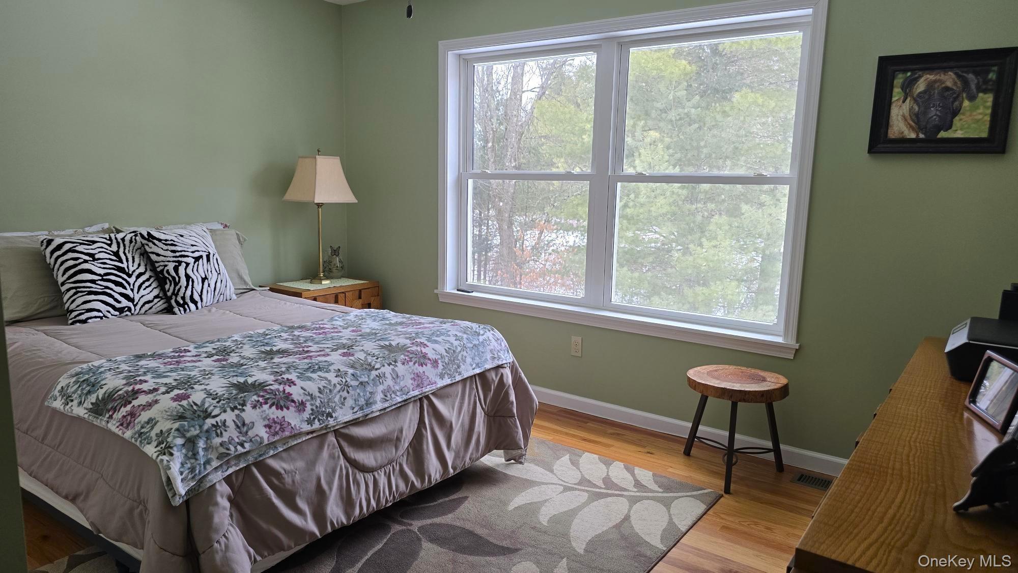 26 Valley Road Forestburgh, NY 12777 - Photo 20 of 32 a bedroom with a bed lamps and a window