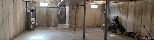 a room with water heater and storage racks