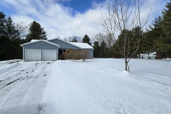 a view of a house with a snow in the yard