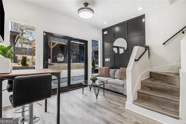 a living room with furniture and wooden floor
