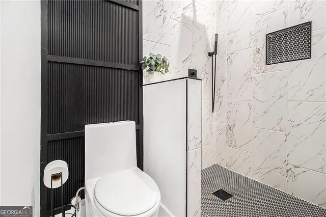 a white toilet sitting next to a bathroom sink