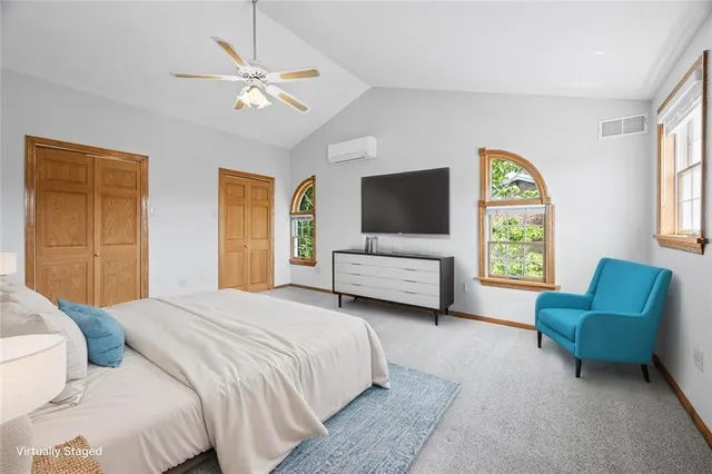 a bedroom with a bed couch and a window