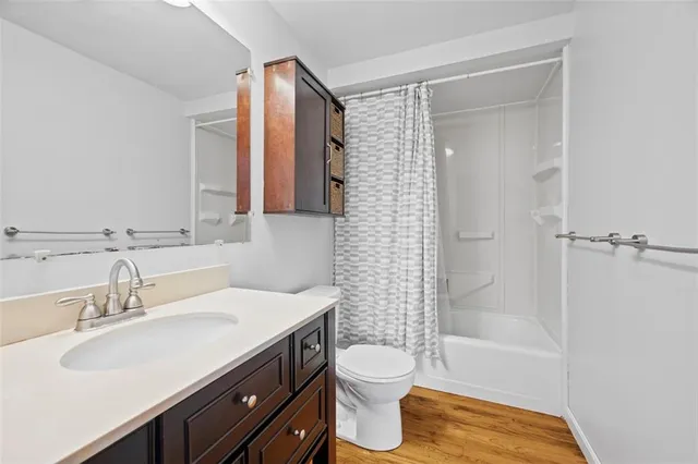 a bathroom with a sink toilet a mirror and shower