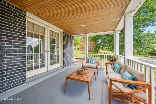 a balcony with furniture and a garden