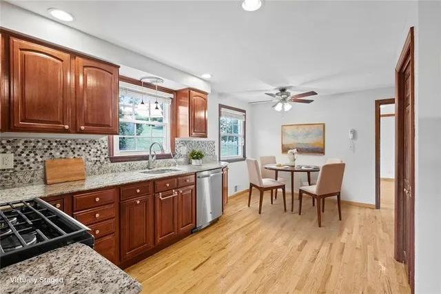a kitchen with granite countertop a sink appliances and cabinets
