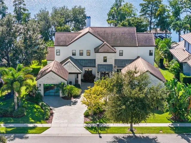a aerial view of a house next to a yard