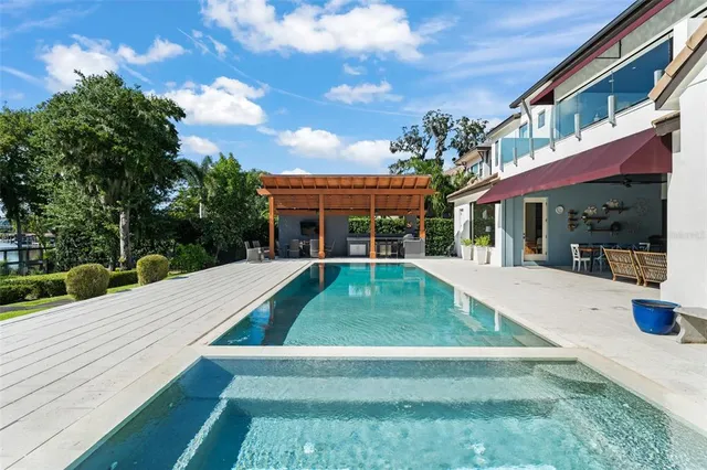 a dining room with furniture a rug and a floor to ceiling window