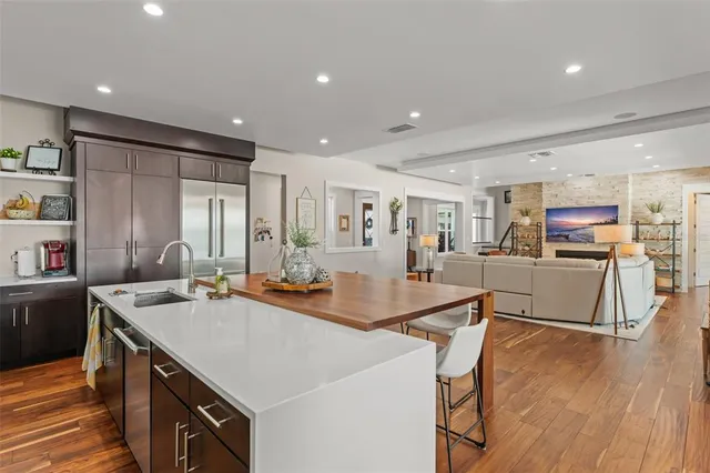 a spacious bathroom with a double vanity sink a large mirror and a shower