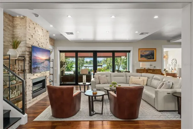 a living room with furniture a large window and a fireplace