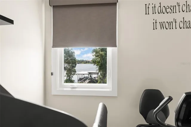 a view of a porch with furniture and a yard