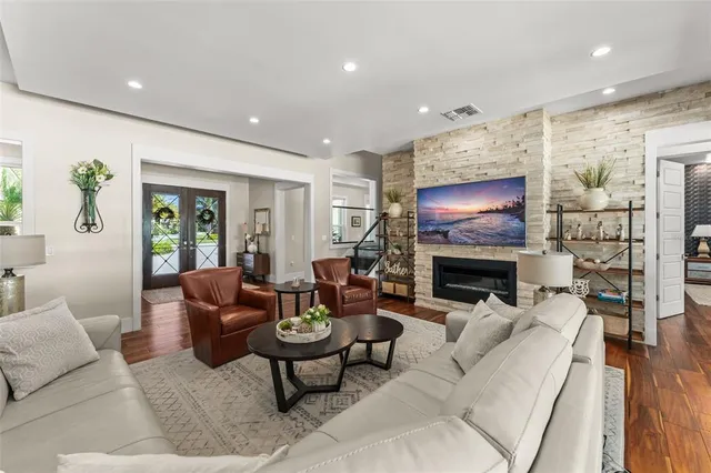 a living room with fireplace furniture and a flat screen tv