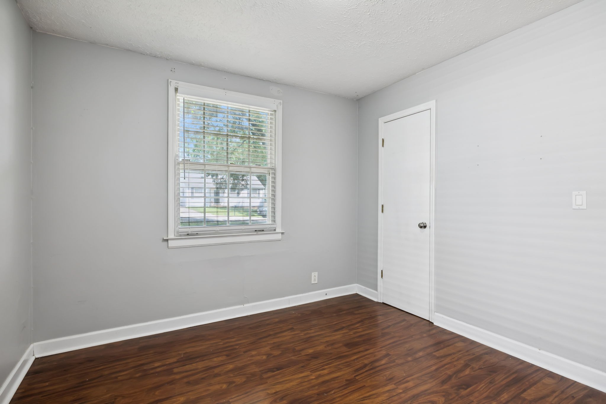 5415 Knob Road Nashville, TN 37209 - Photo 18 of 28 a view of an empty room with wooden floor and a window