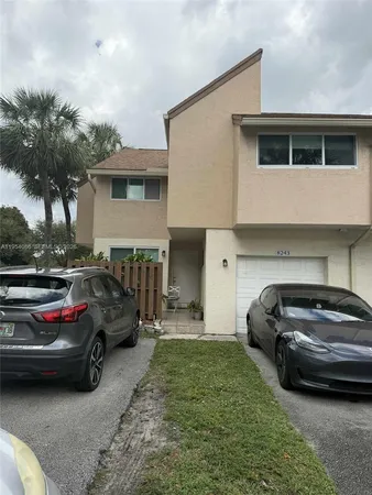 a view of cars parked in front of a house