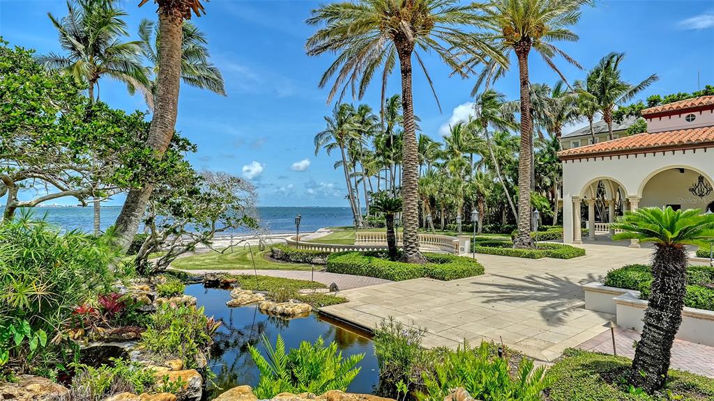 4423 Bay Shore Road Sarasota, FL 34234 - Photo 13 of 51 a view of a yard with plants and palm trees