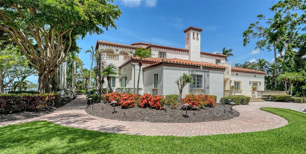 4423 Bay Shore Road Sarasota, FL 34234 - Photo 19 of 51 a front view of a house with a garden and trees