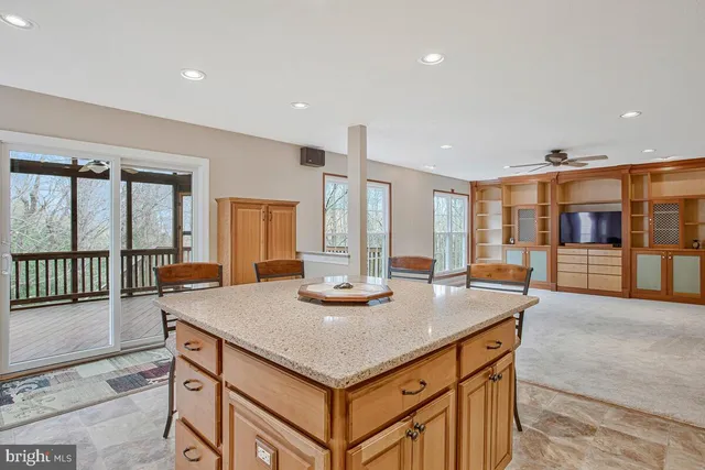 a view of kitchen island a sink and living room