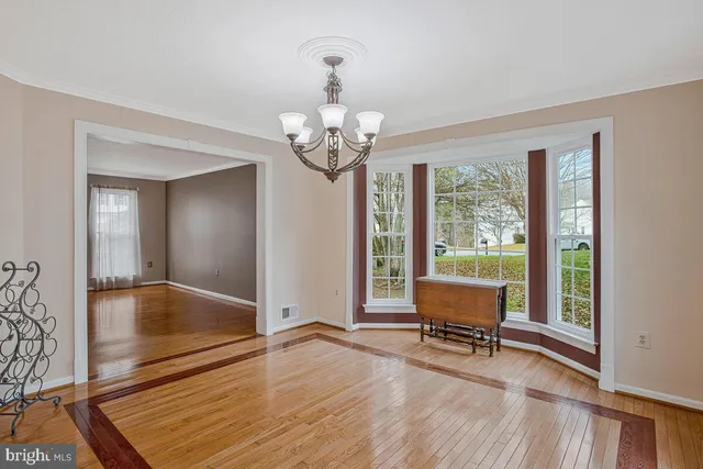 a view of a livingroom with wooden floor and furniture