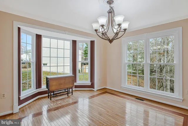 a view of a dining room with furniture windows and wooden floor