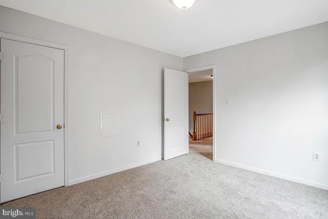 a view of an empty room with closet area