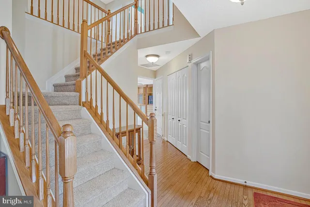 a view of staircase with railing and white walls