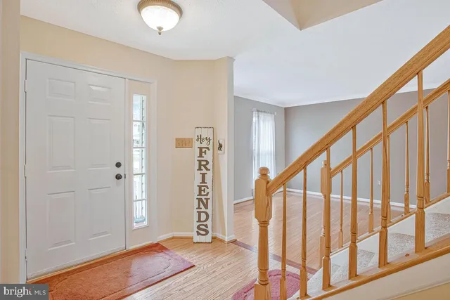 a view of an entryway with wooden floor and stairs