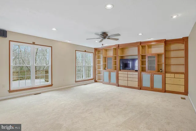 a view of an empty room with a window and a bathroom