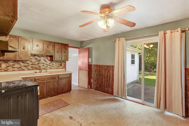 a kitchen with stainless steel appliances granite countertop a stove a refrigerator a sink and dishwasher with wooden floor