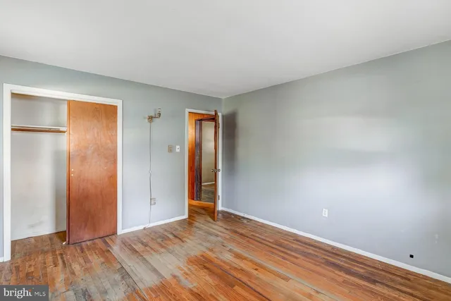 a view of an empty room and wooden floor