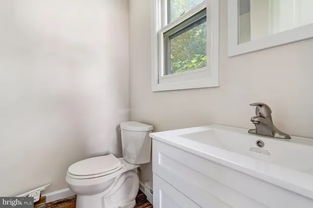 a white toilet sitting next to a bathroom sink