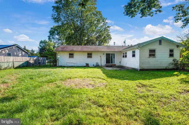 a view of house with yard and green space