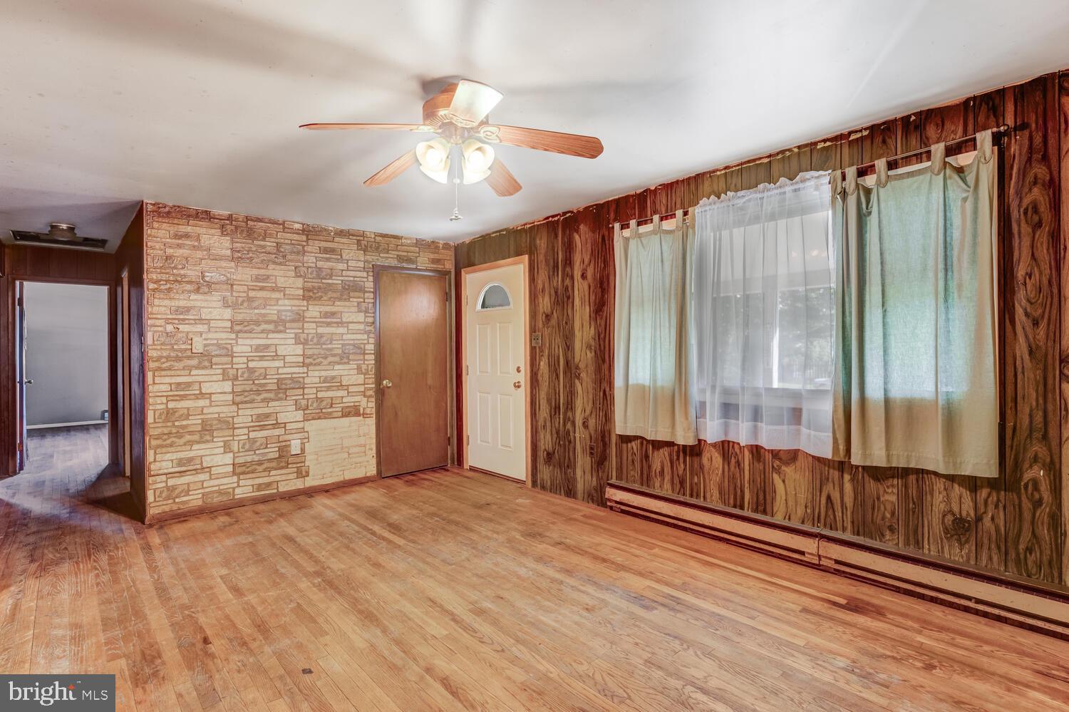 123 Jericho Road Tuckerton, NJ 08087 - Photo 9 of 29 an empty room with wooden floor fan and windows