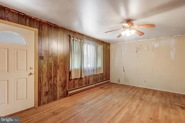 wooden floor in an empty room with a window