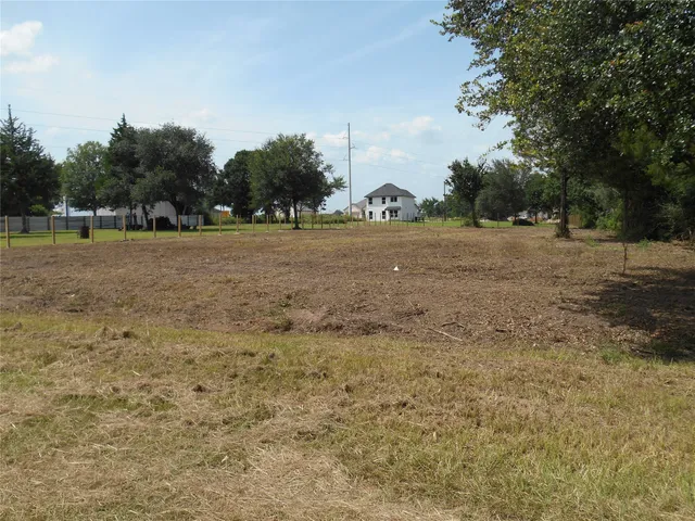 a view of dirt field with trees