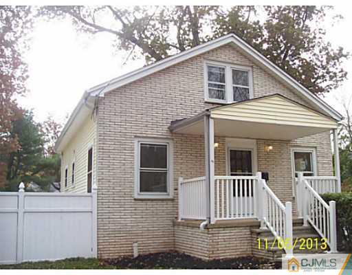 243 Walnut Street Dunellen, NJ 08812 - Photo 1 of 18 a front view of a house with a yard