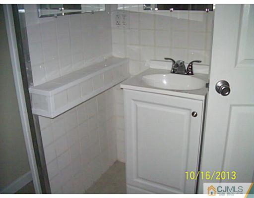 243 Walnut Street Dunellen, NJ 08812 - Photo 11 of 18 a bathroom with a sink toilet and shower