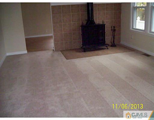 243 Walnut Street Dunellen, NJ 08812 - Photo 3 of 18 a view of an empty room with a fireplace