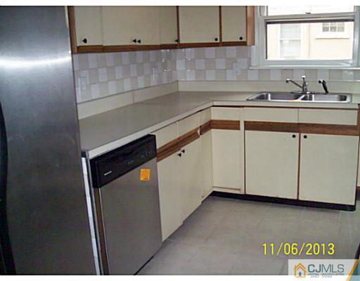 243 Walnut Street Dunellen, NJ 08812 - Photo 7 of 18 a kitchen with a sink and cabinets