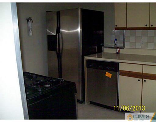 243 Walnut Street Dunellen, NJ 08812 - Photo 8 of 18 a kitchen with a sink and a refrigerator