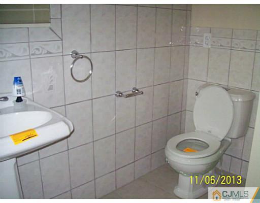 243 Walnut Street Dunellen, NJ 08812 - Photo 9 of 18 a bathroom with a toilet and a sink